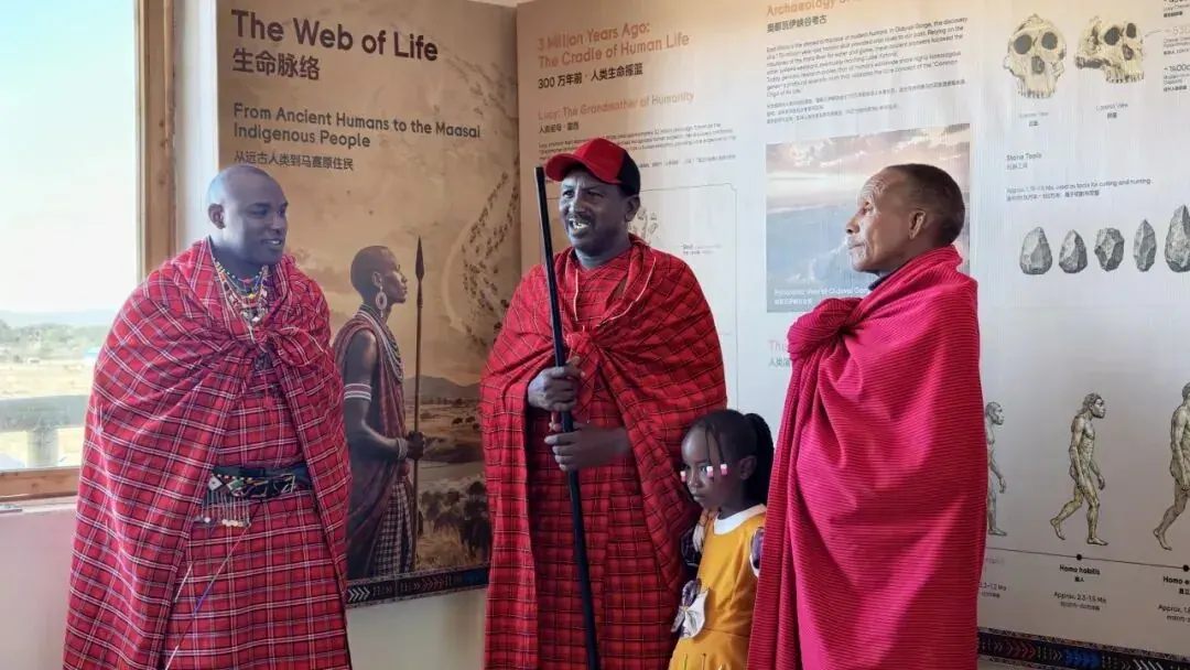 'Passing the Future' — a Maasai elder with the Eng'udi staff, children at his side